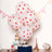Red polka dot balloons with a gift box and decorative items in a festive setting.