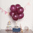 Purple balloons with a gift box and decorations for a festive celebration.