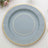 Round blue plate with gold trim on a white table setting.