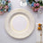 Elegant decorative plate with gold detailing on a white background.