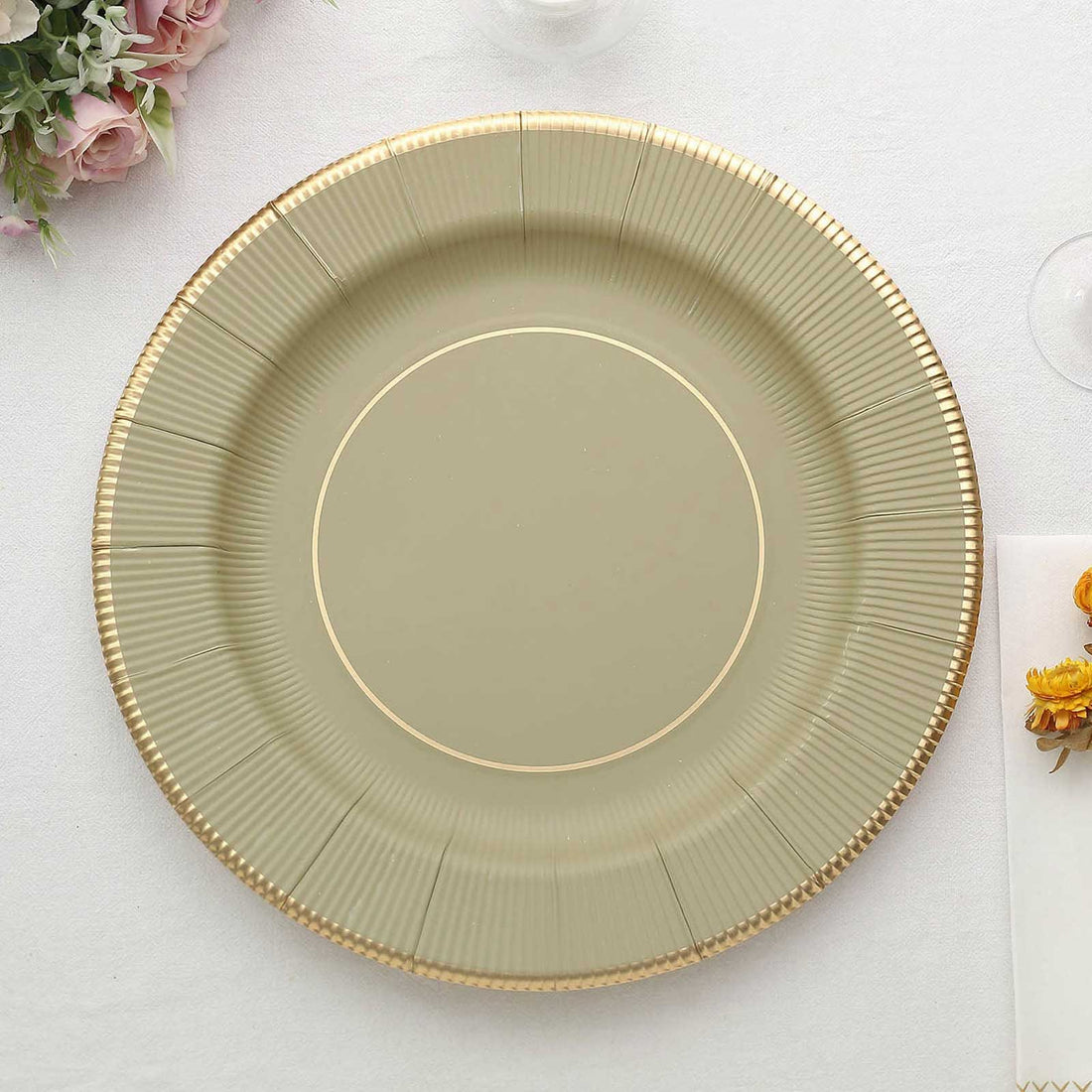 Green decorative plate with gold rim on a white background.
