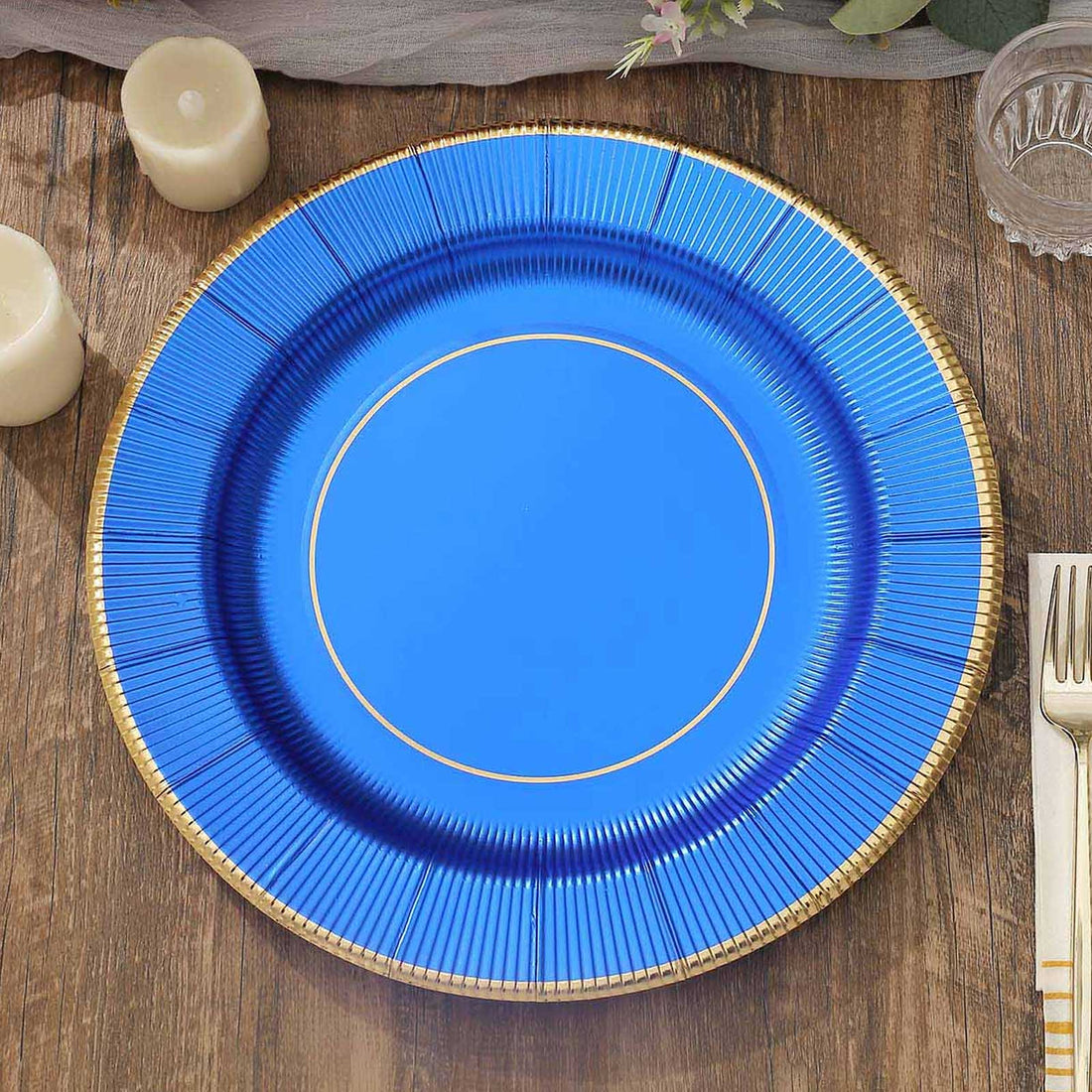 Blue decorative plate with gold trim on a wooden surface.