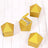 Gold geometric gift boxes in various positions on a wooden surface.