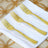Set of three elegant gold forks on a white napkin.