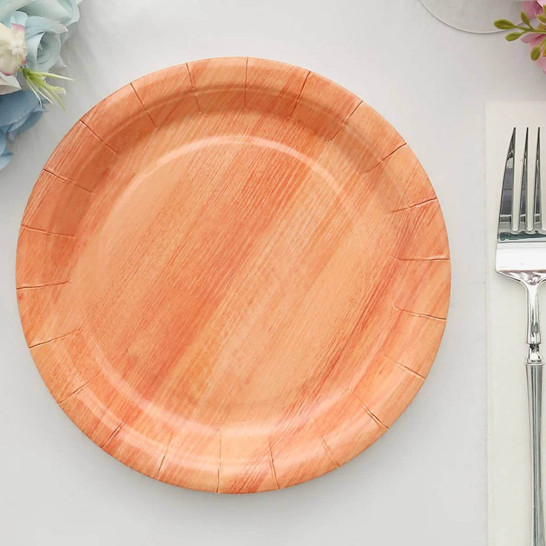 Disposable wooden look plate on a table setting.