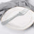 Silver fork on an elegant plate with a gray linen napkin.