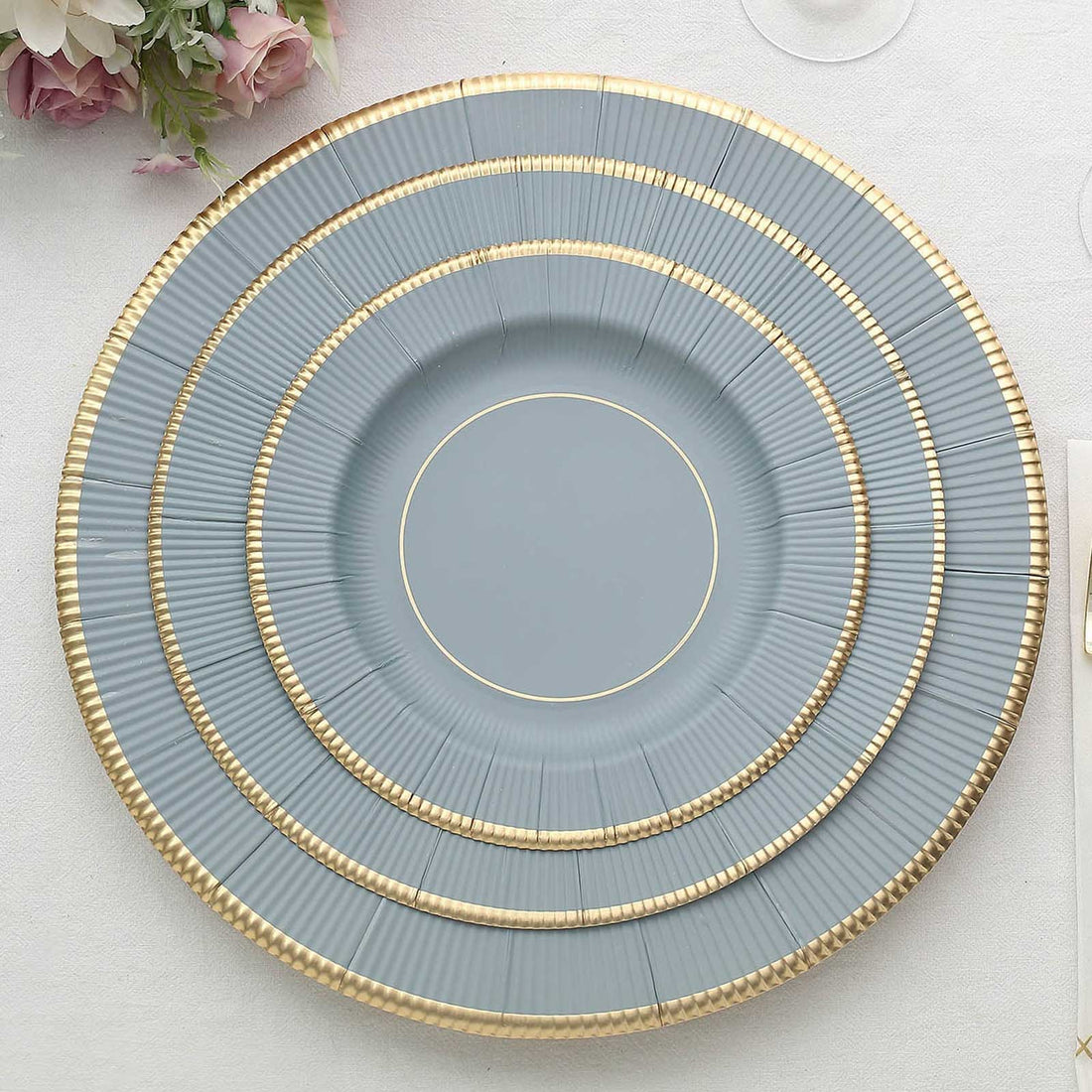 Elegant blue plate set with gold accents on a white background.
