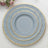 Elegant blue plate set with gold accents on a white background.