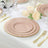 Elegant pink and gold dinnerware set on a beautifully arranged dining table.