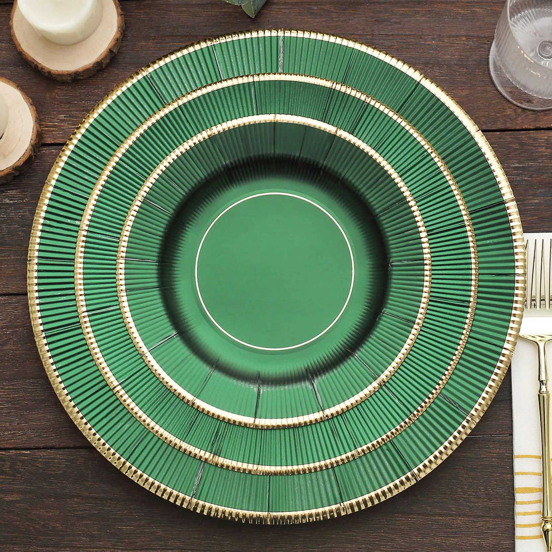 Green decorative plate with gold accents on a wooden table.