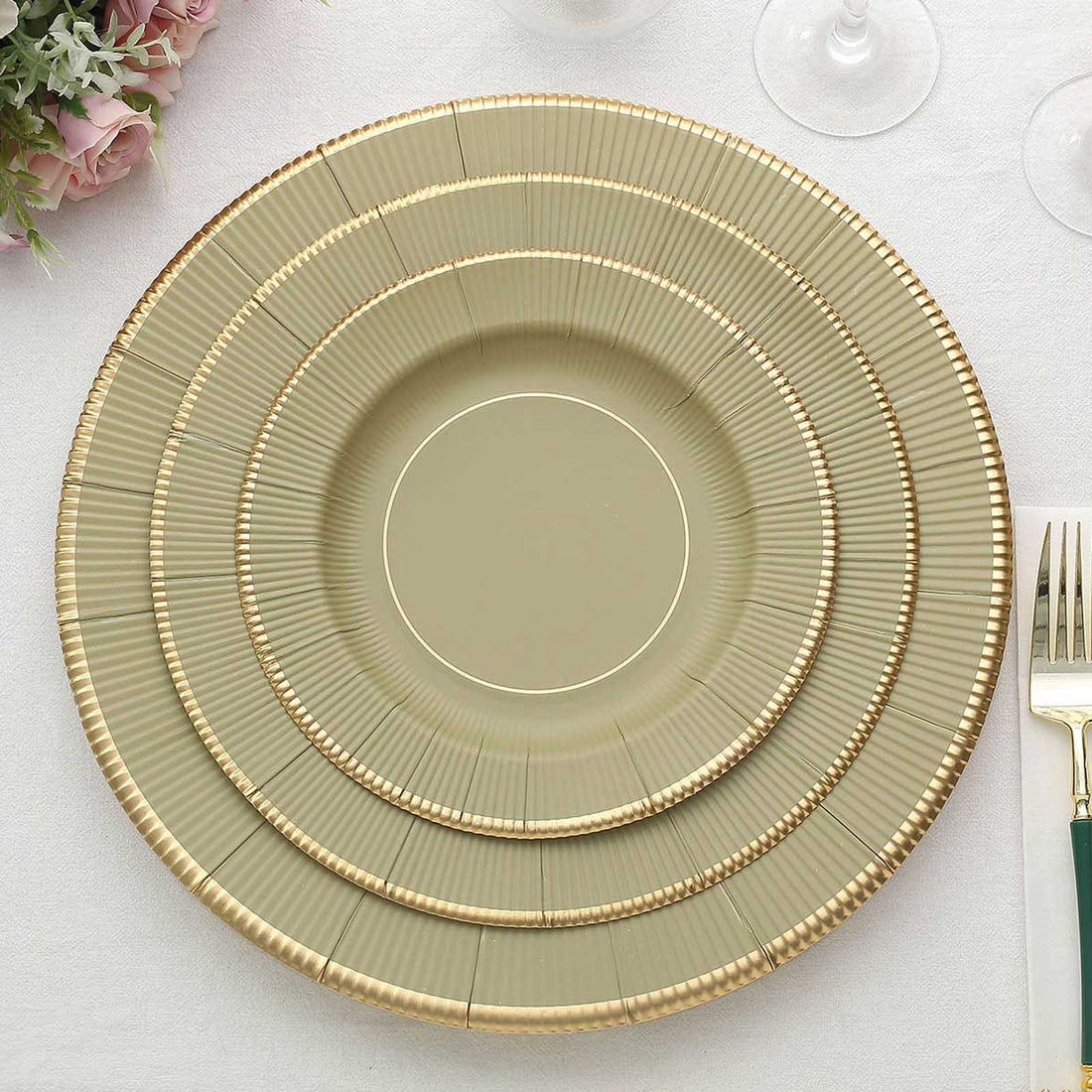 Elegant stacked dinner plates with gold accents on a white background.