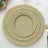Elegant stacked dinner plates with gold accents on a white background.