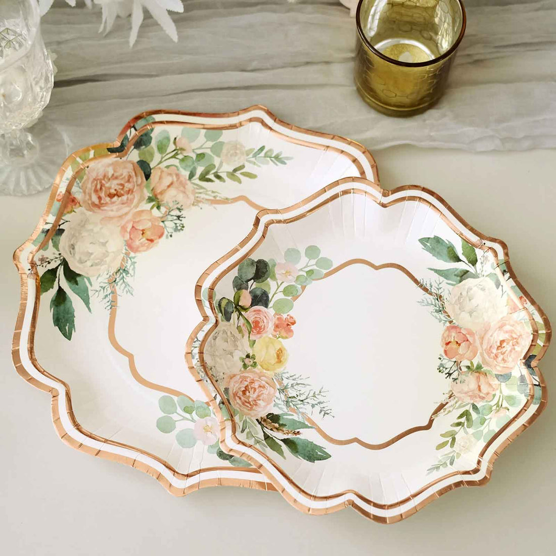 Floral paper plates in elegant shapes with gold accents and pastel flowers.