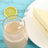 Chocolate milkshake in a glass with a striped straw and a slice of lemon