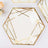Hexagon-shaped clear plate with gold geometric design accents.
