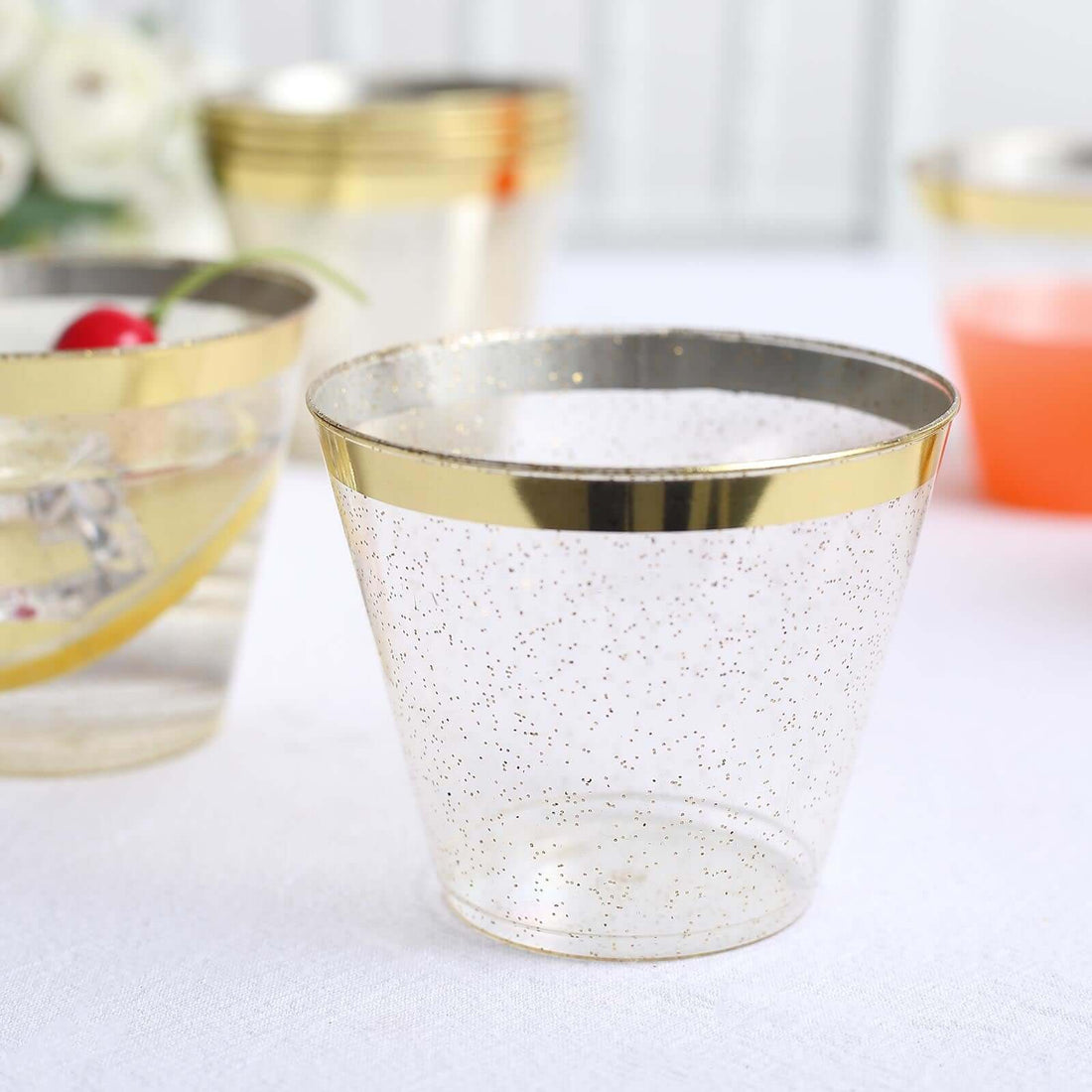 Clear plastic cup with gold rim and glitter accents. Perfect for parties.