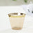 Clear plastic cup with a gold rim on a white surface.