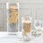 Decorative glass vases with floating candles and gold foliage accents.