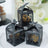 Decorative black lantern boxes with intricate cutout designs.