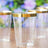 Clear drinking glasses with gold rim against a floral background.