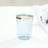 Blue plastic cup with gold band on top