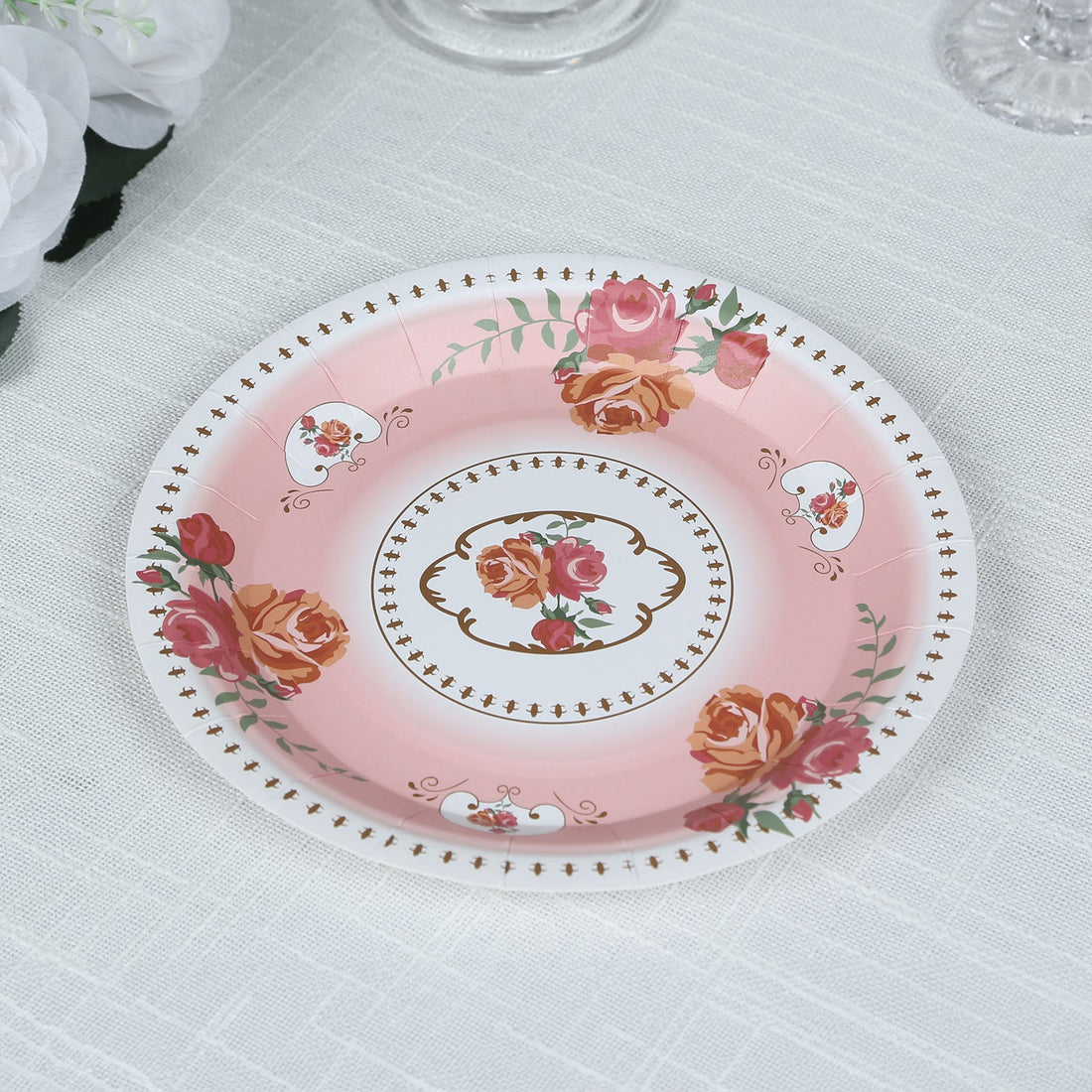 Decorative pink plate with floral design and elegant gold accents