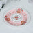 Decorative pink plate with floral design and elegant gold accents