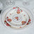 Floral-patterned dinner plates stacked on a textured tablecloth.