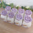 Decorative purple rose gift boxes arranged neatly on a wooden surface.