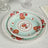 Floral patterned dinner plates stacked on a table setting.