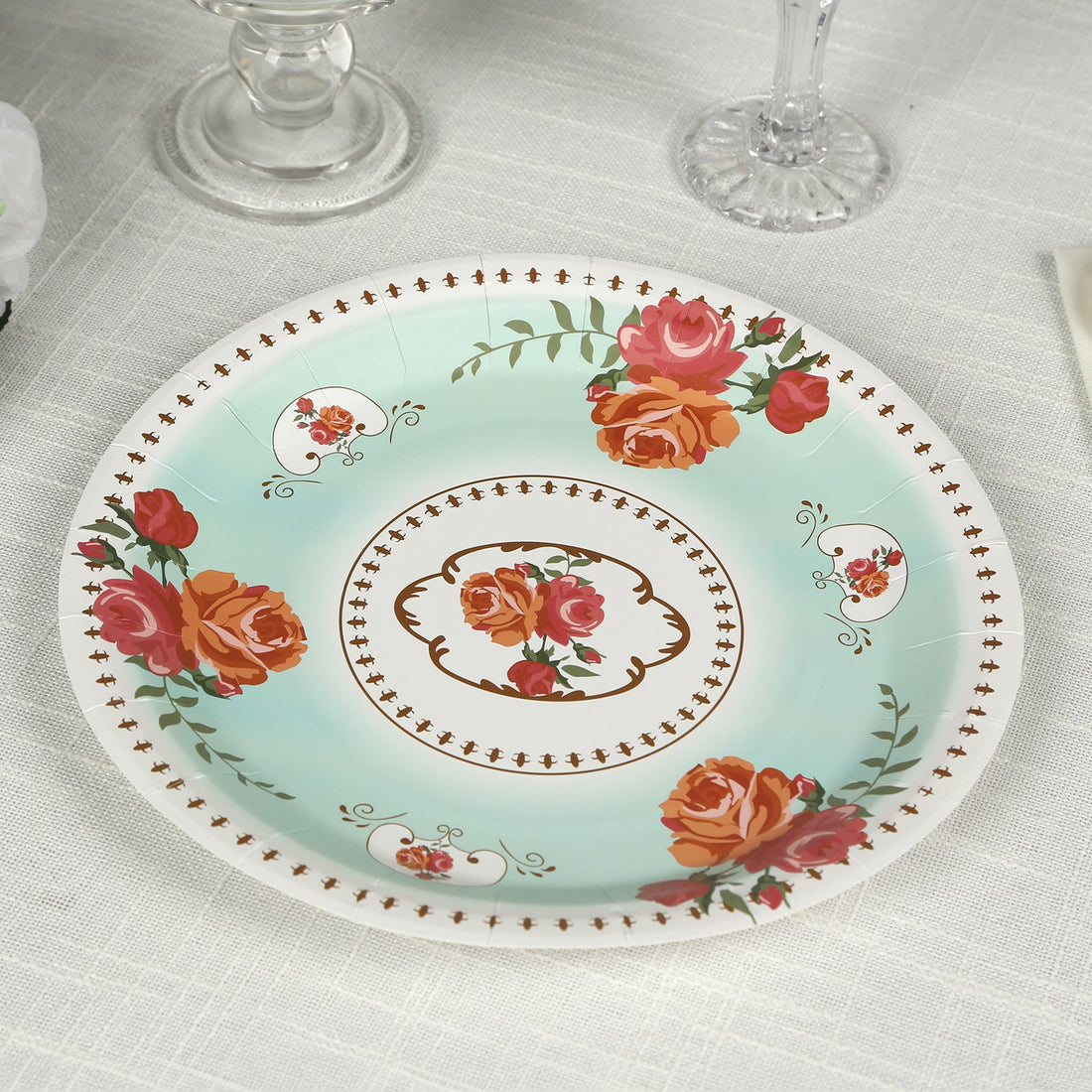 Floral decorative plate with roses on a light blue background.