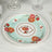 Floral decorative plate with roses on a light blue background.