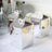Silver gift boxes with butterfly tops on a table setting.
