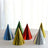 Colorful party hats in various metallic shades arranged on a table.