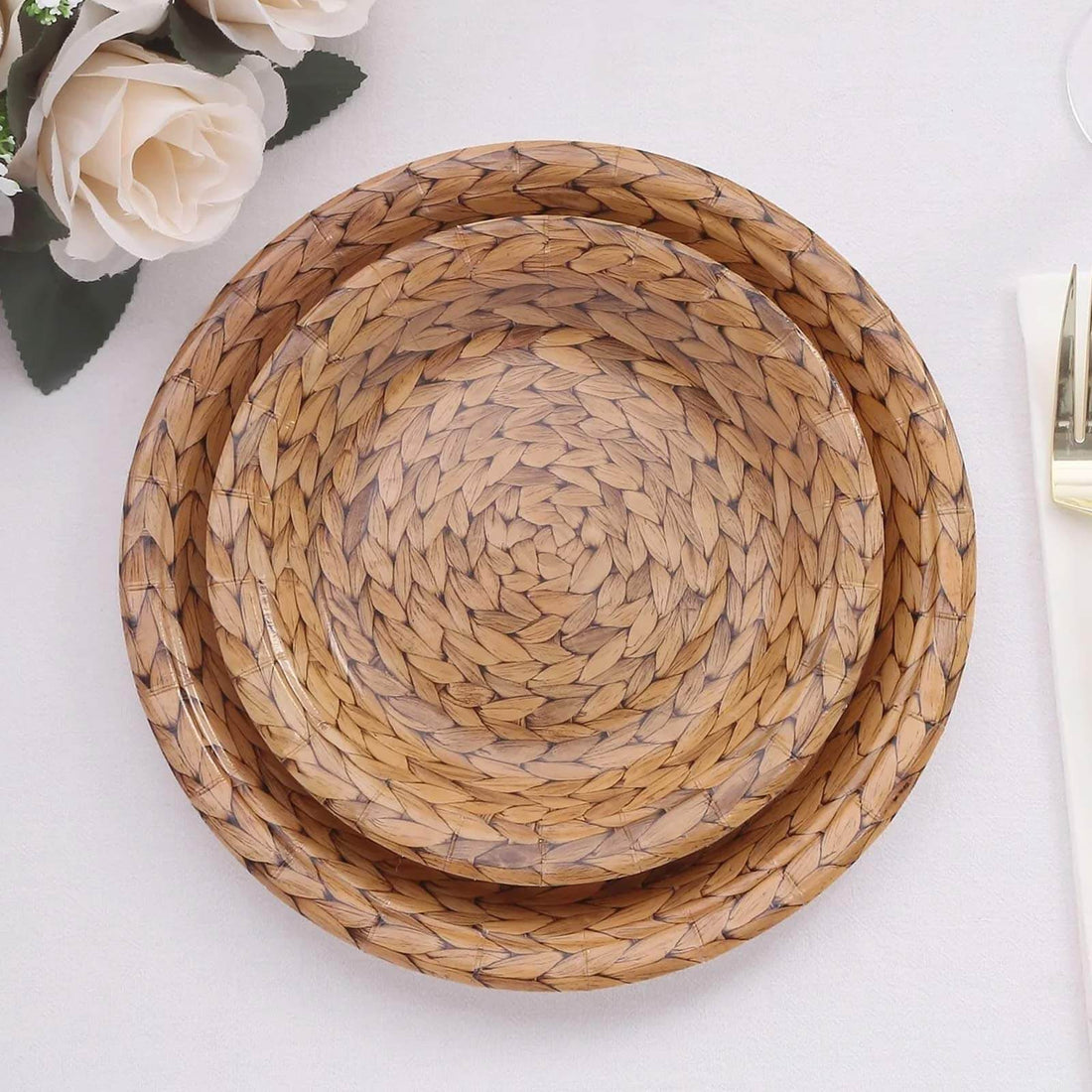 Woven wooden plates stacked together on a light surface.