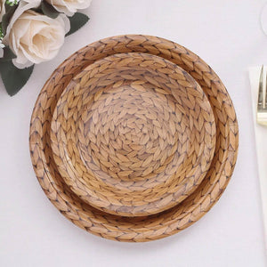 Woven wooden plates stacked together on a light surface.