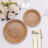 Woven bamboo plates set with elegant gold cutlery and floral arrangement.