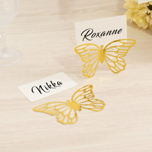 Gold butterfly place cards with names for elegant table settings.
