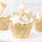 Decorative cupcakes with golden lace wrappers and cream frosting.