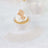 Elegant lace cupcake wrappers with gold accents and whipped cream topping.