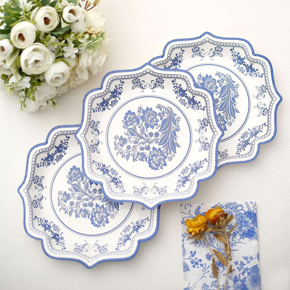 Three decorative blue and white plates arranged on a table.