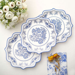Three decorative blue and white plates arranged on a table.