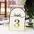 Elegant table number sign with gold accents, featuring "table 3" in a stylish font.