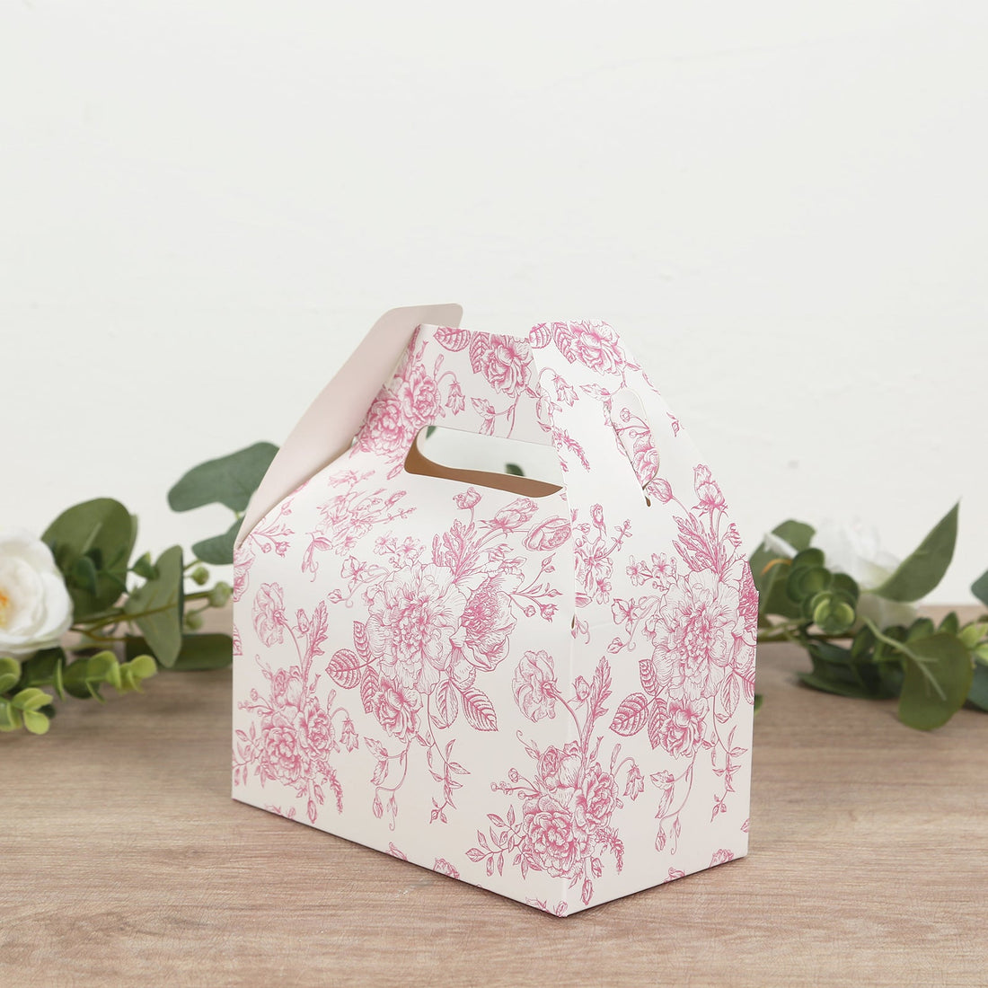 Floral patterned gift box with handle for special occasions.