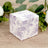 Floral-patterned gift box with purple design on a light background.