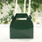 Green takeaway box with handle on a table setting.