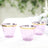 Set of three elegant purple plastic cups with gold rims.