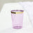 Purple plastic cup with gold rim on a plain surface.