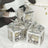 Decorative silver lanterns with intricate floral design and butterfly tops.