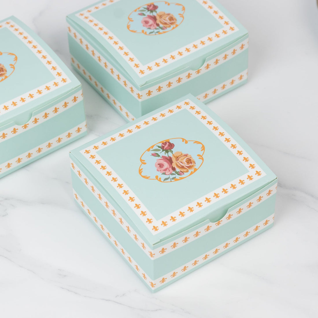 Decorative floral storage box with mint green design and orange accents.